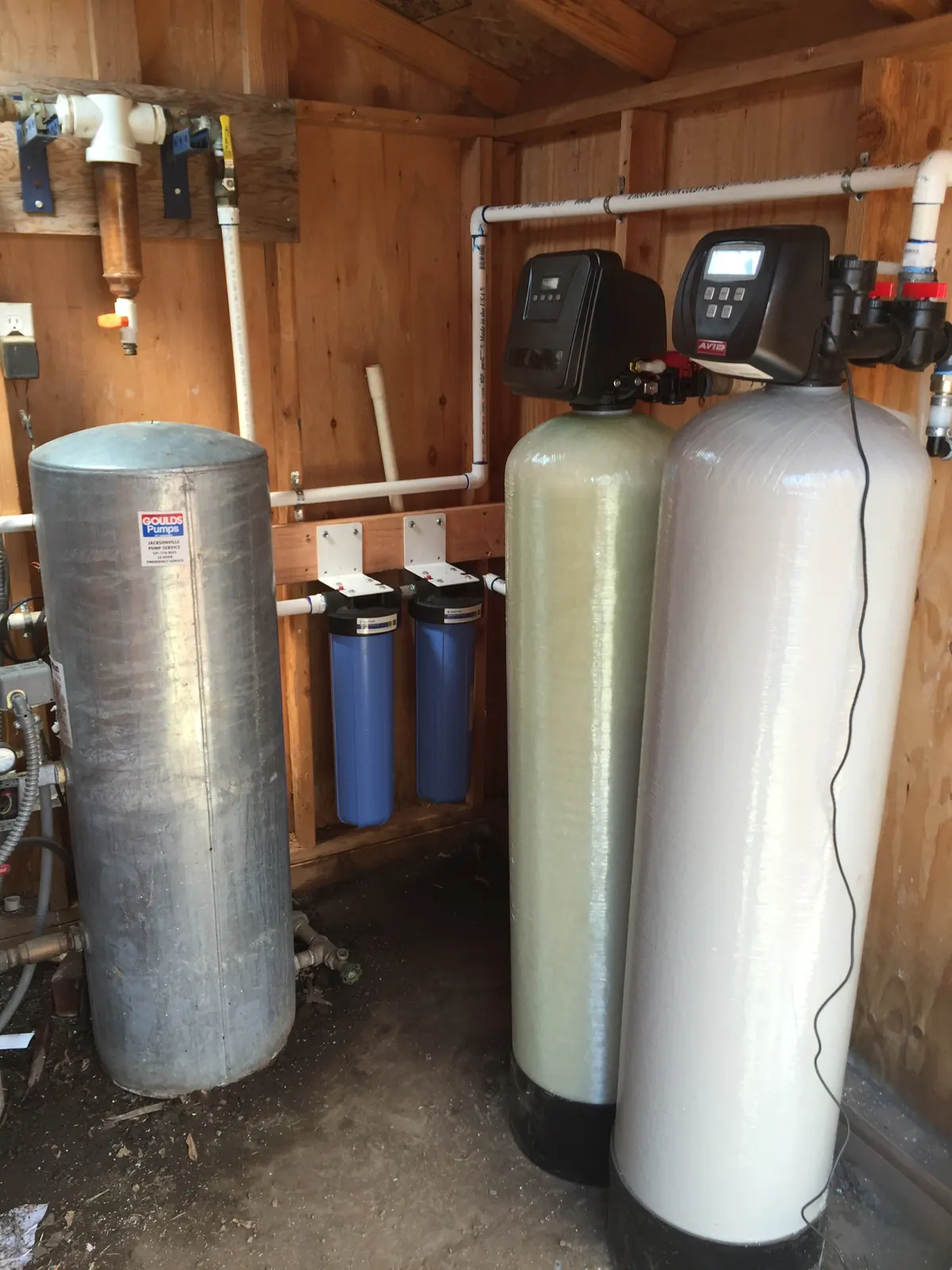 Well-water stack — bladder tank, prefilters, and dual media.
